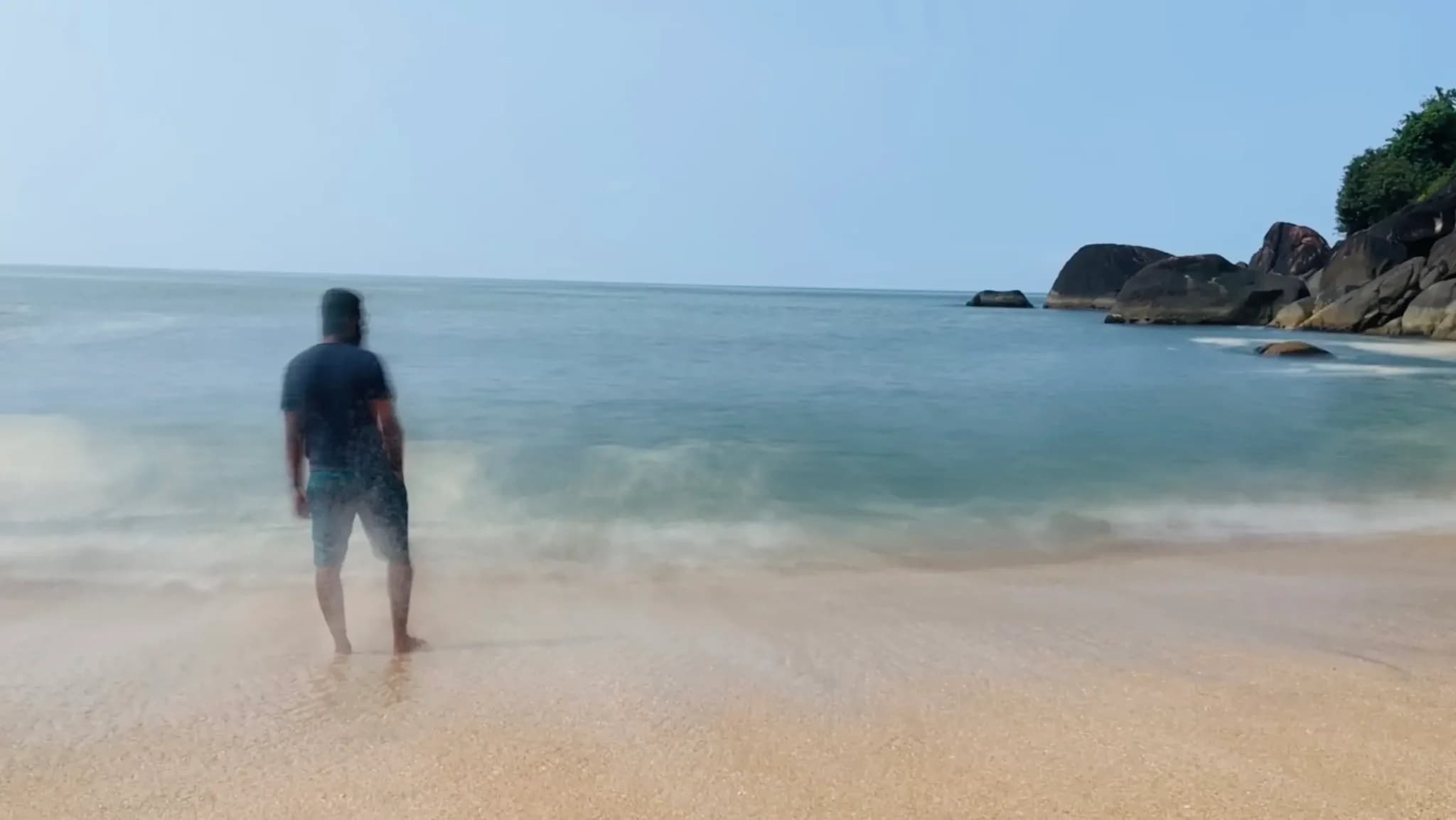 Person standing at Butterfly Beach, Goa