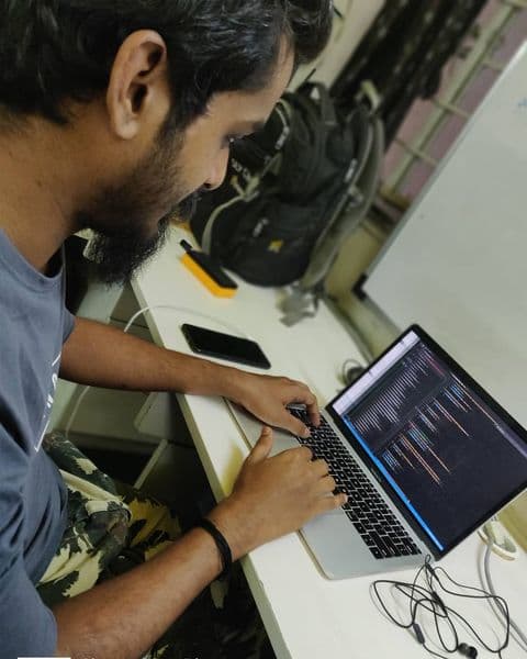 Girish working on a laptop at the office